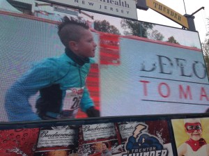 The finish line in sight and all on the 'jumbotron' for the crowd to watch